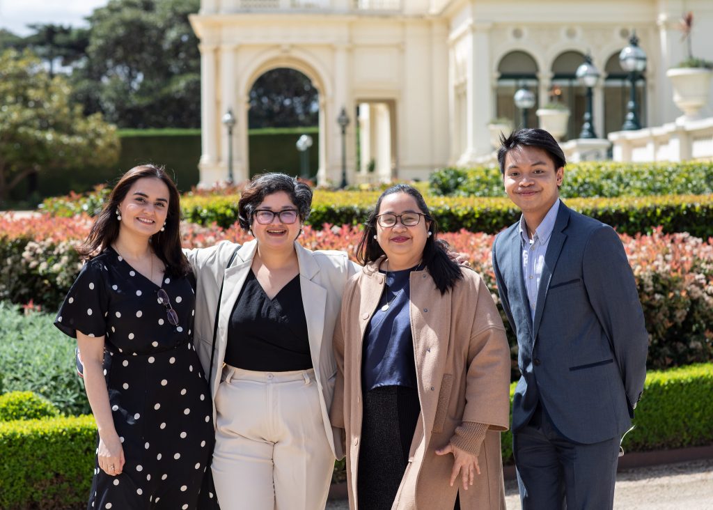 Sujita (second from left) photographed with other Australia Awards scholars during the 2024 End of Year event at Melbourne Government House.