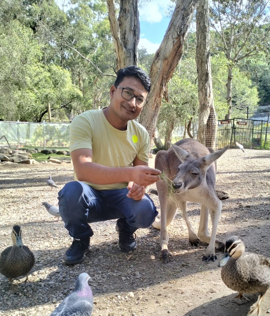 Melsan feeding a kangaroo at Brisbane Forest Park during a field visit organised under the Australia Awards Short Course.