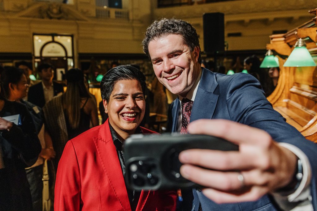 Shailee taking a selfie with Hon Tim Watts MP at the 2025 End of Year event in Melbourne, organised by Australia Awards.