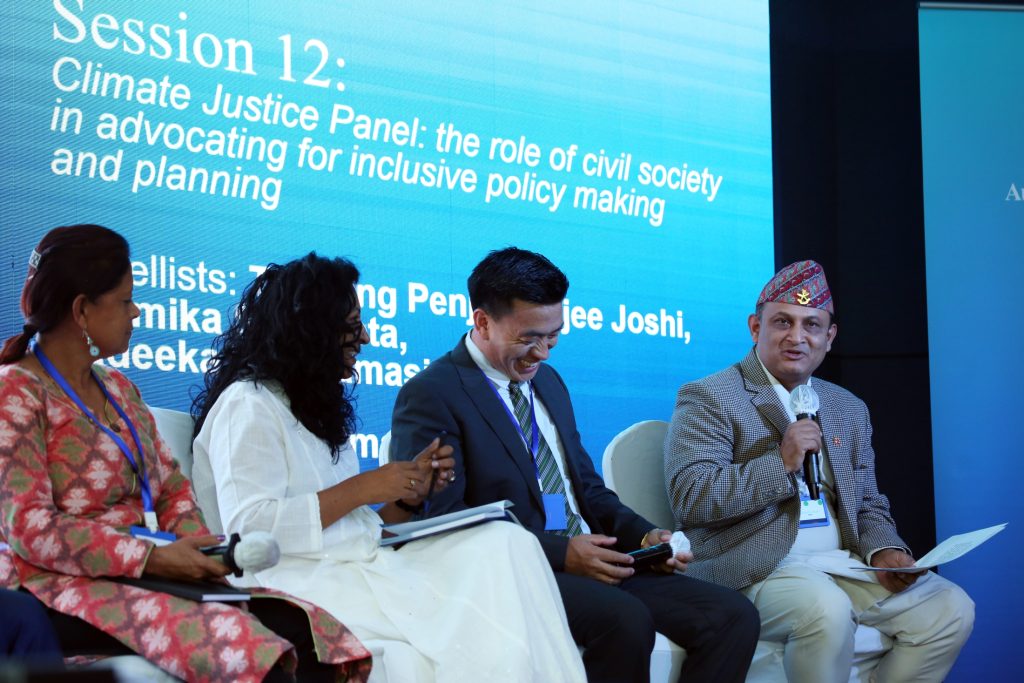 Dr Bimal Raj Regmi (right) moderating a panel discussion on climate justice at the 2023 Regional Alumni Workshop in Ulaanbaatar, Mongolia.